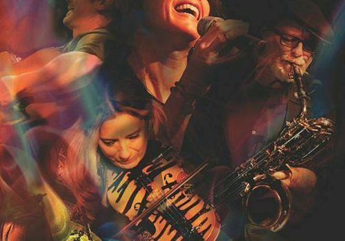 The image shows a vibrant collage of musicians performing with instruments, featuring vivid lights and colors surrounding them.